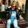 lady with denim dress and black coat